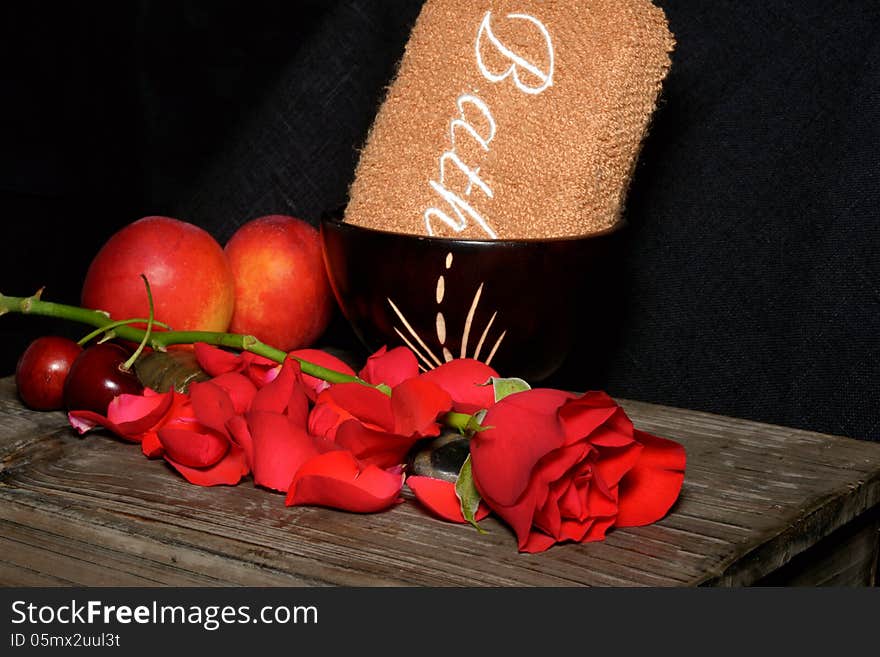 Spa stones, fruit and roses on black background. Spa stones, fruit and roses on black background