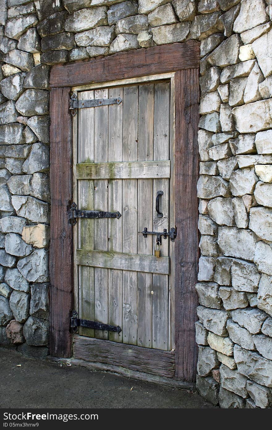 Very old wood door in a stone wall. Very old wood door in a stone wall