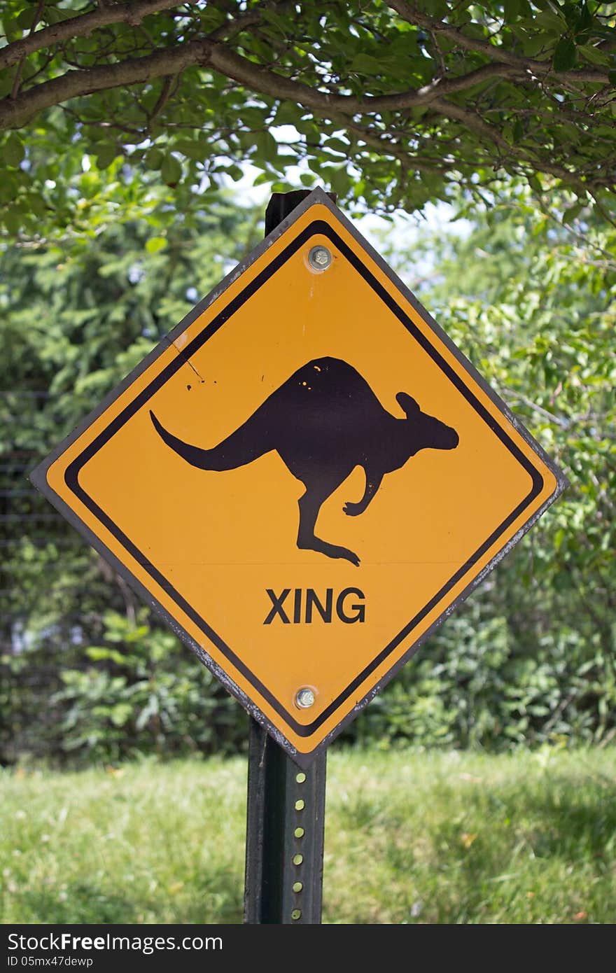 Orange kangaroo crossing warning sign