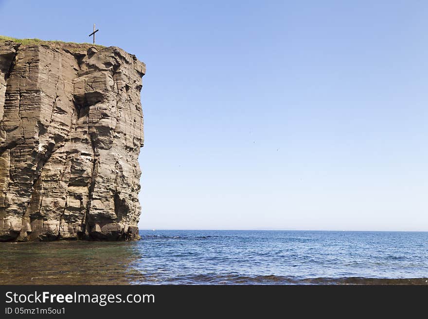 The sea and rocks under beams of a bright sun