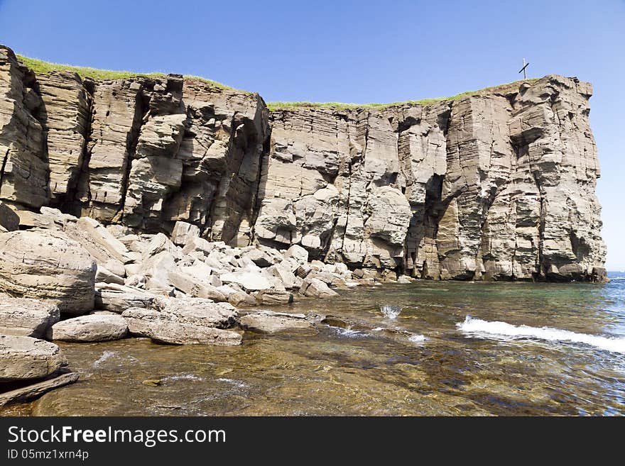 The sea and rocks under beams of a bright sun