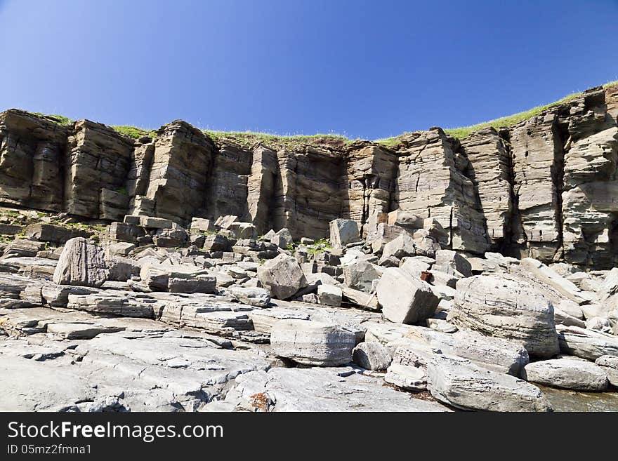 Rocks and stones on the seashore in a hard-to-reach spot