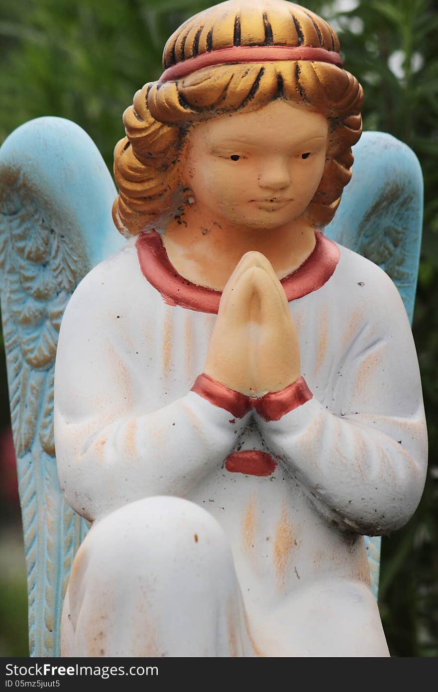 Figure of a praying angel in the cemetery