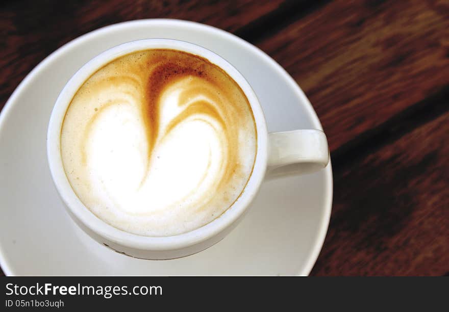 Cup of coffee on wooden background