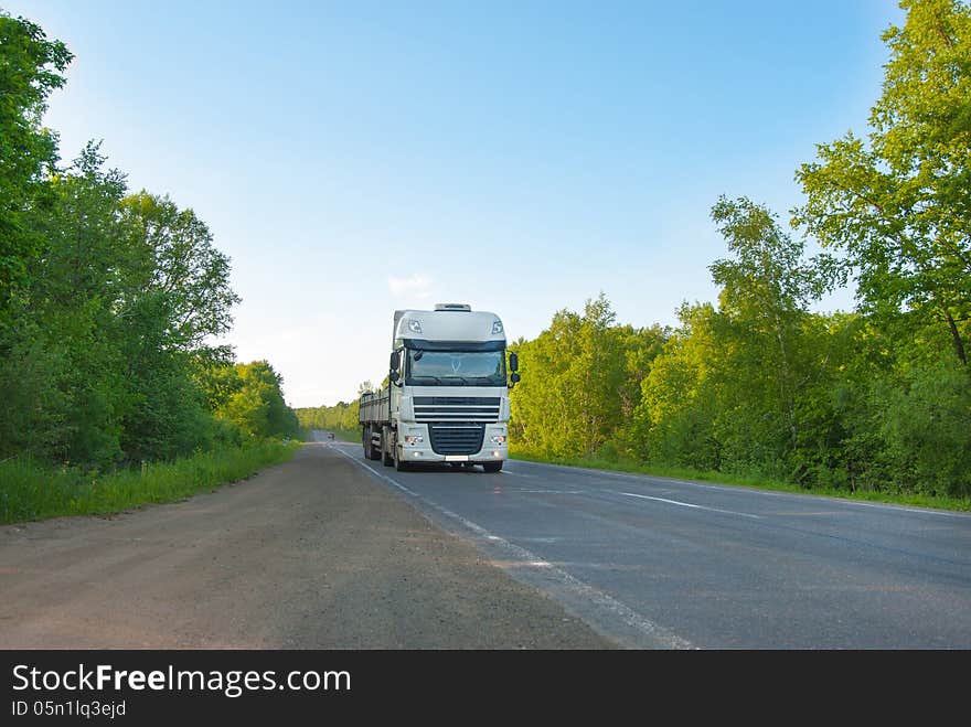 The gray truck on the road in movement