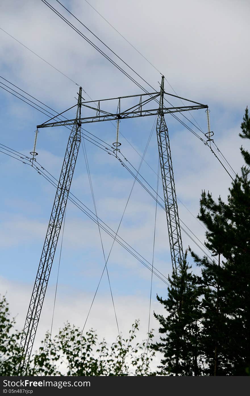 High voltage mast against the sky