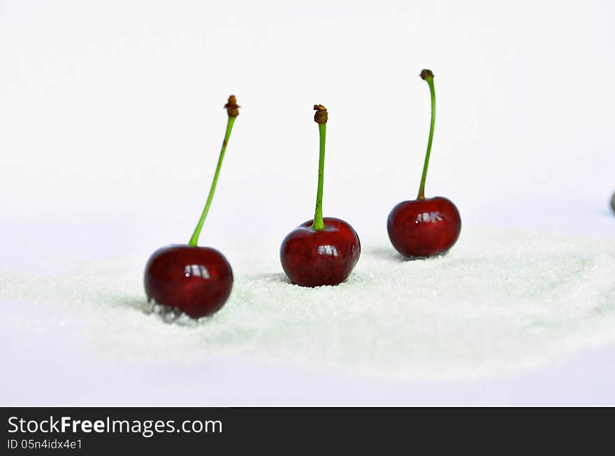 Three sweet cherries on a white background. Three sweet cherries on a white background