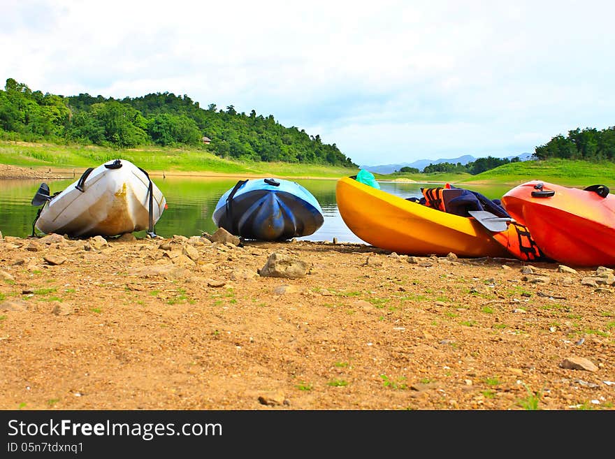 Kayaks, Canoe  On The Edge Of The Water In Lake