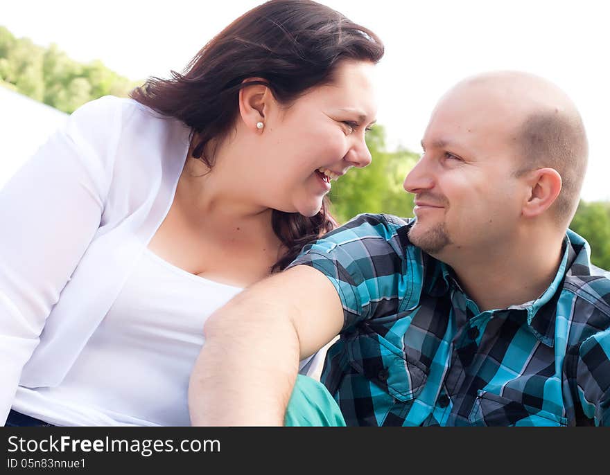 Happy young couple is having fun on a windy park beach. Happy young couple is having fun on a windy park beach