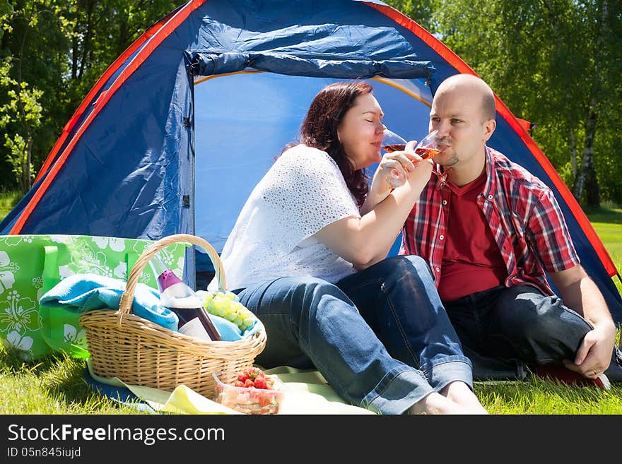 Happy young couple is relaxing on a camping. Happy young couple is relaxing on a camping