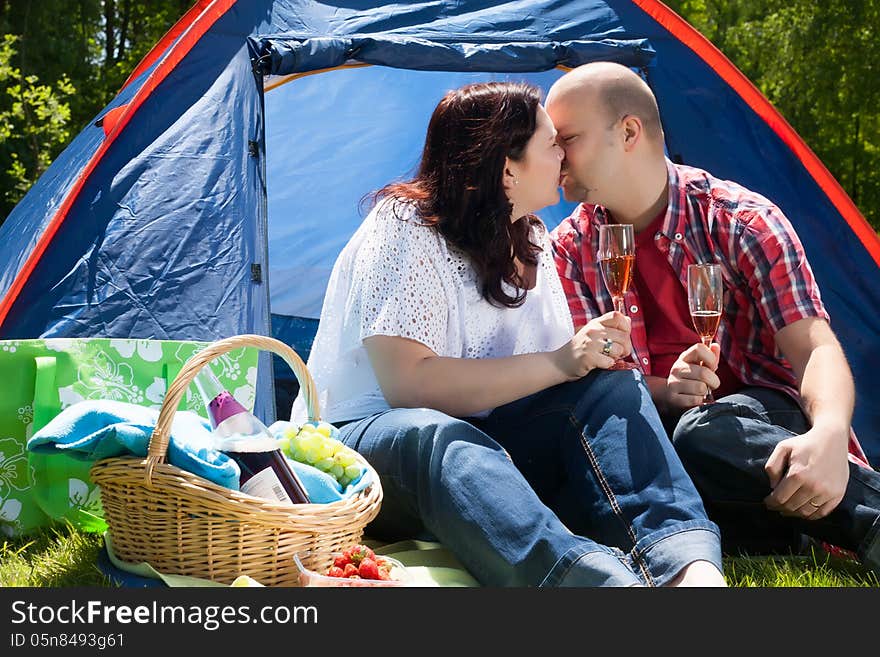 Happy young couple is relaxing on a camping. Happy young couple is relaxing on a camping