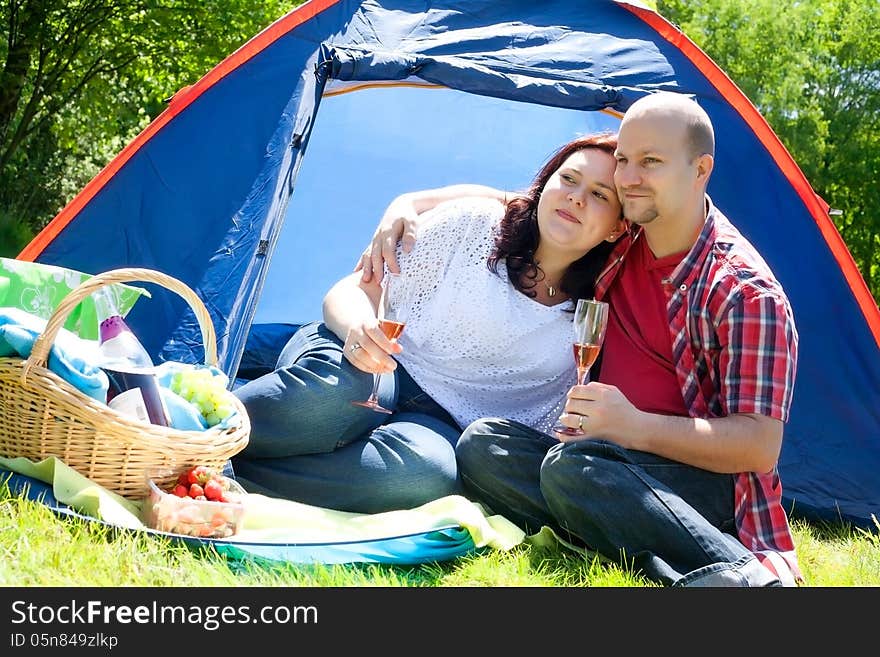 Happy young couple is relaxing on a camping. Happy young couple is relaxing on a camping