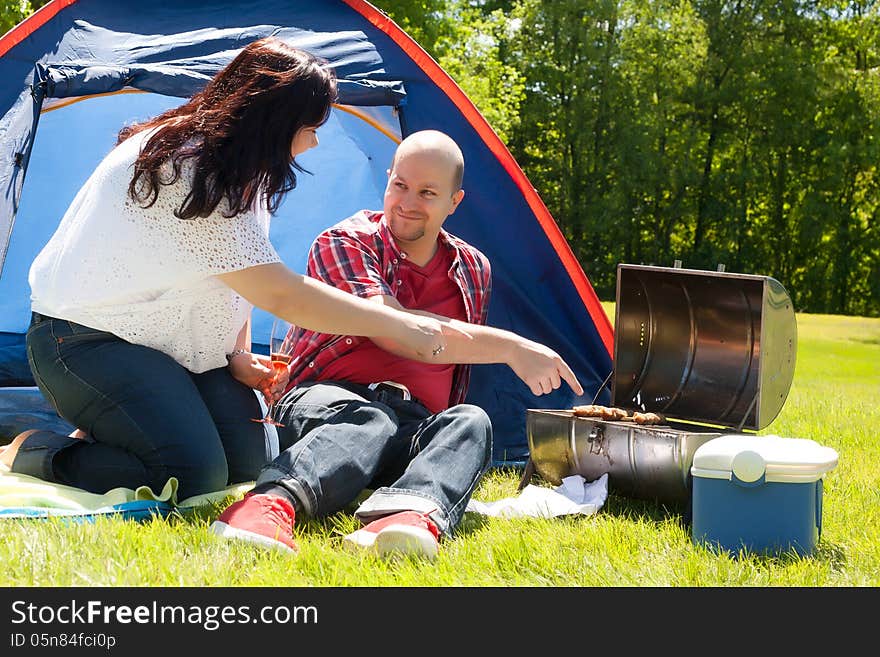 Happy young couple is relaxing on a camping. Happy young couple is relaxing on a camping