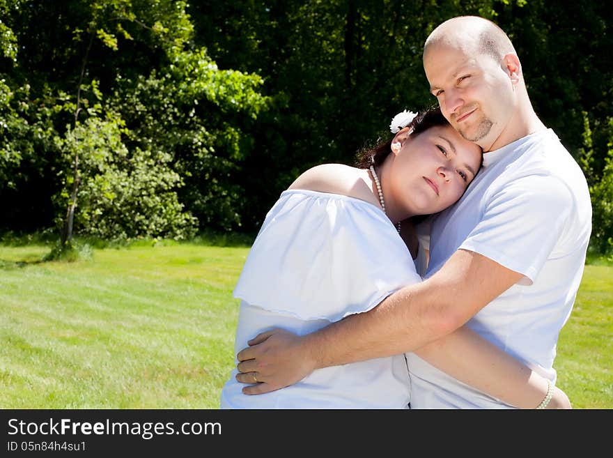 Happy young couple dressed white in the nature. Happy young couple dressed white in the nature