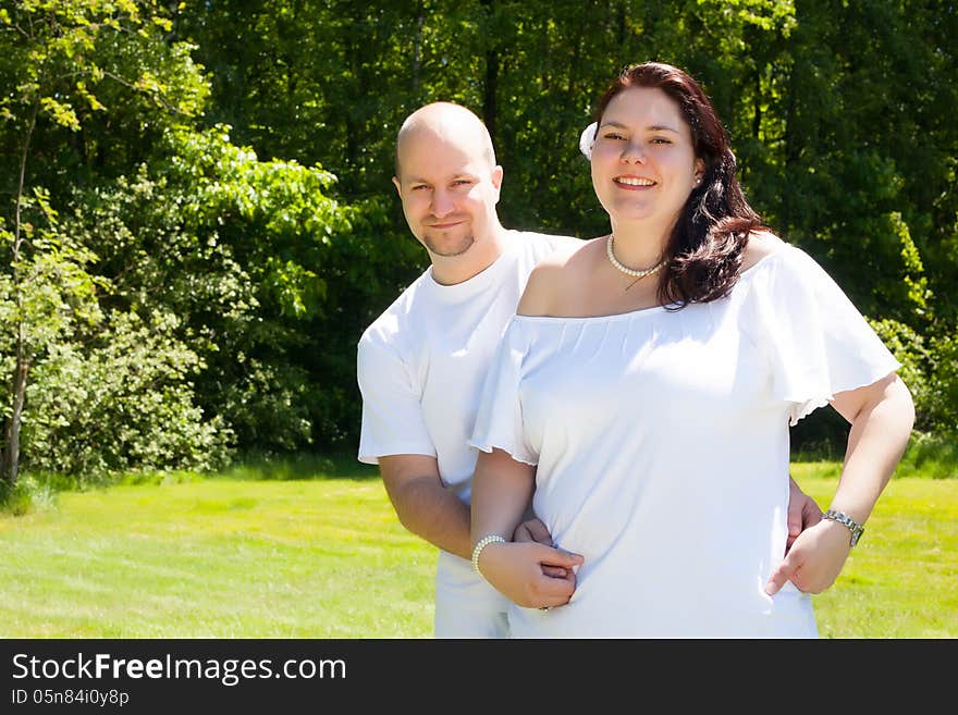 Happy young couple dressed white in the nature. Happy young couple dressed white in the nature