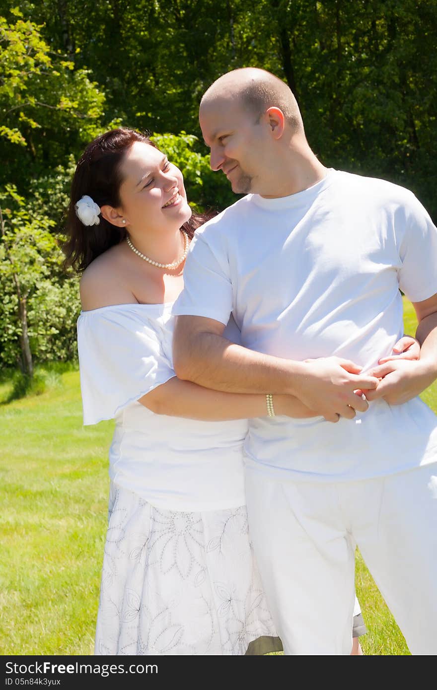 Happy young couple dressed white in the nature. Happy young couple dressed white in the nature