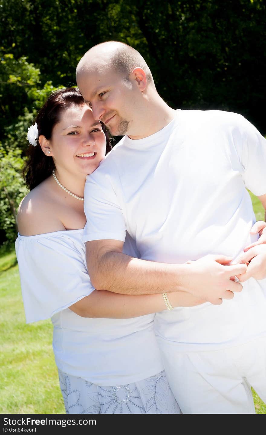 Happy young couple dressed white in the nature. Happy young couple dressed white in the nature