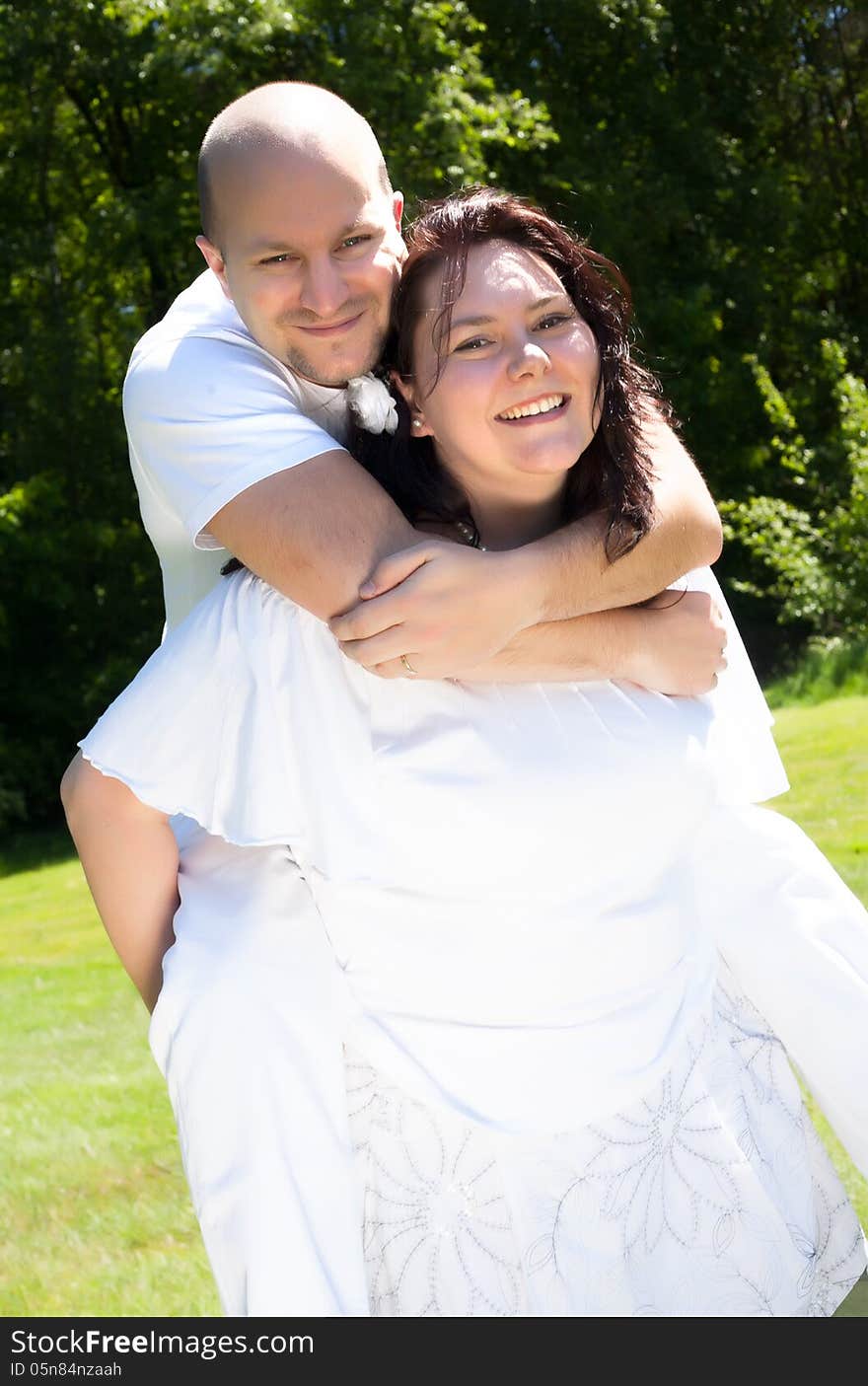 Happy young couple dressed white in the nature. Happy young couple dressed white in the nature