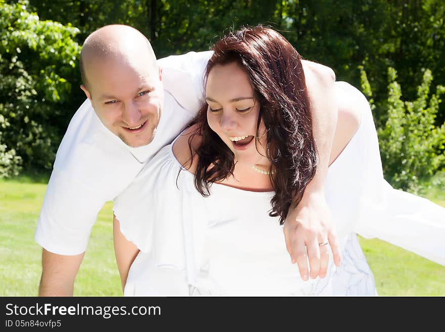 Happy young couple dressed white in the nature. Happy young couple dressed white in the nature