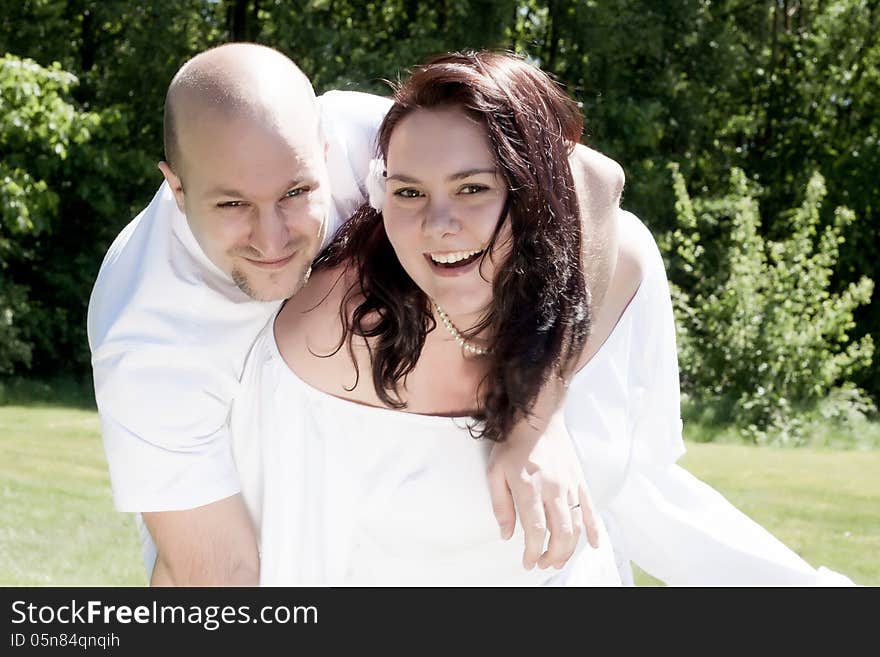 Smiling happy couple in white