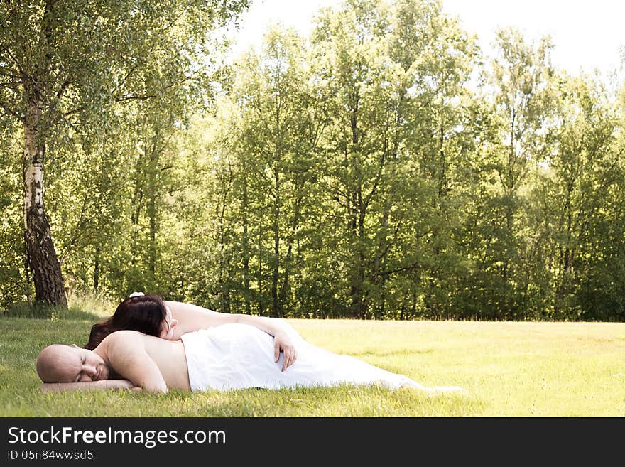 Happy young couple dressed white in the nature. Happy young couple dressed white in the nature