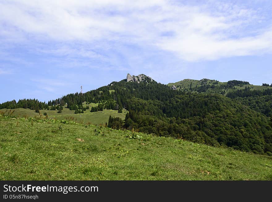 Summer mountain route, partly with storm clouds