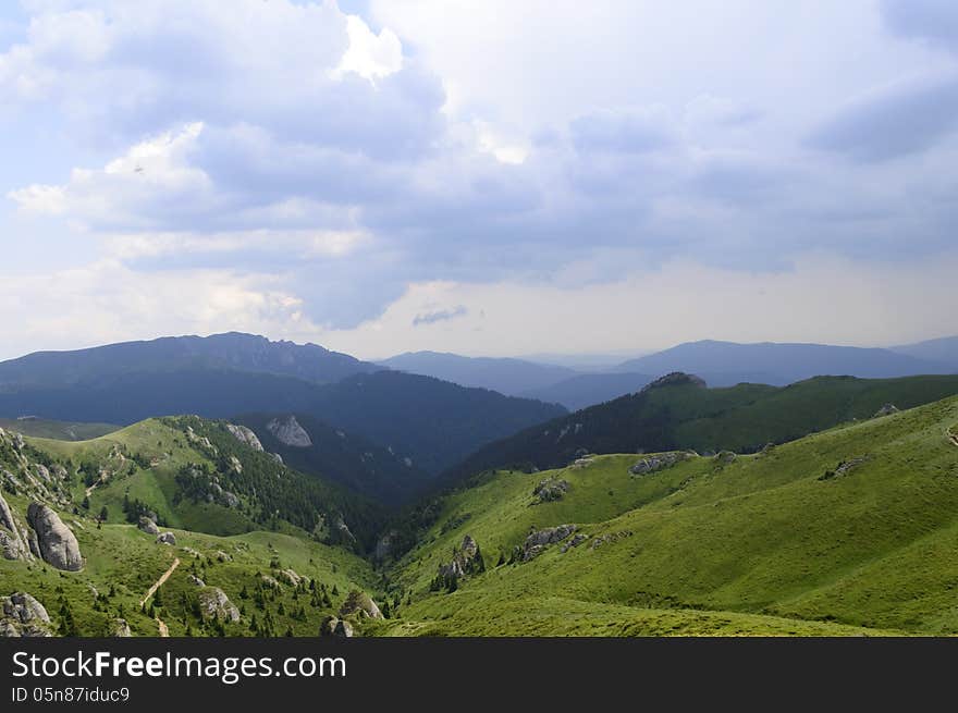 Summer mountain route, partly with storm clouds