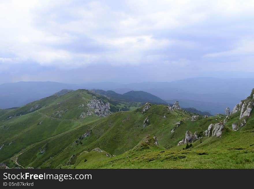 Summer mountain route, partly with storm clouds