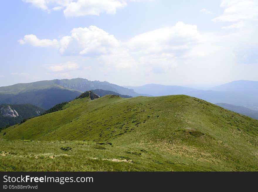 Summer mountain route, partly with storm clouds