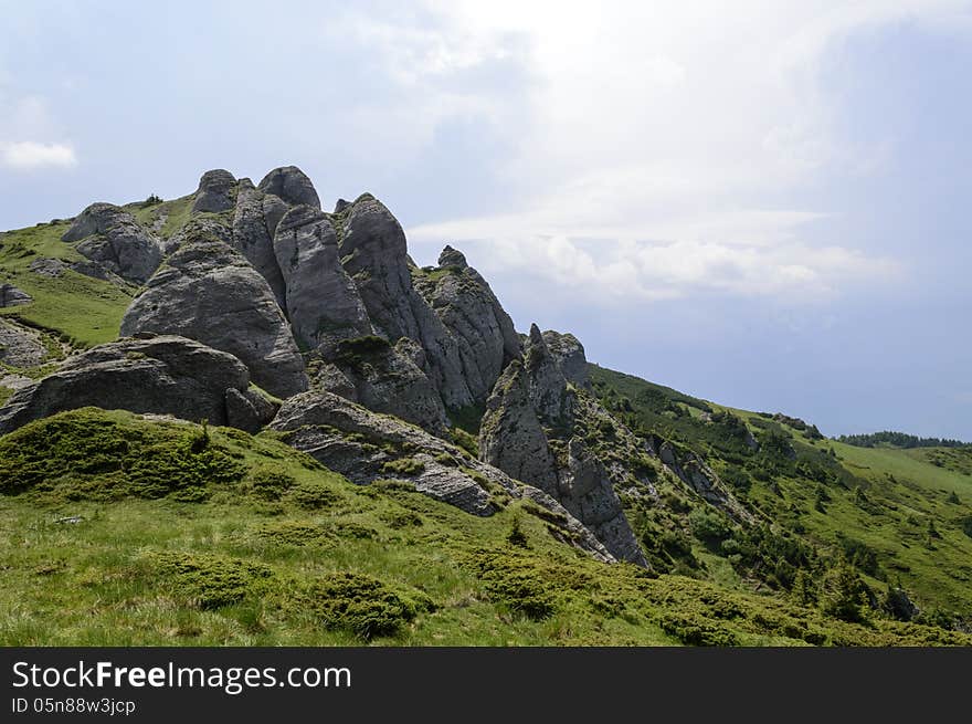 Summer mountain route, partly with storm clouds