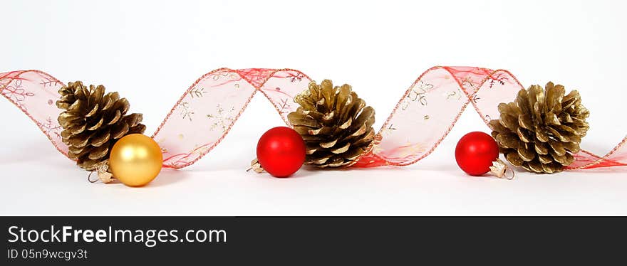 Baubles and cones with the ribbon on the white background. Baubles and cones with the ribbon on the white background