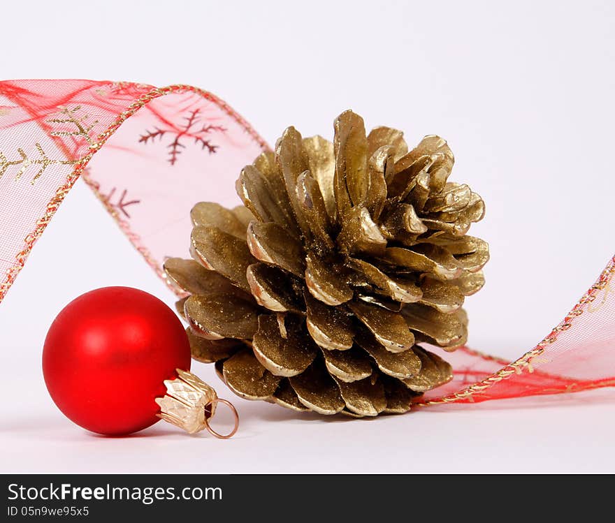 Bauble and cone with the ribbon on the white background. Bauble and cone with the ribbon on the white background