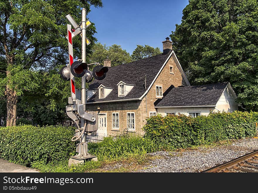 House at the railway crossing on a nice afternoon