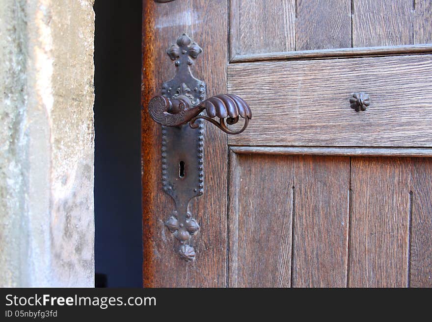 Historical door detail with metal latch. Historical door detail with metal latch.