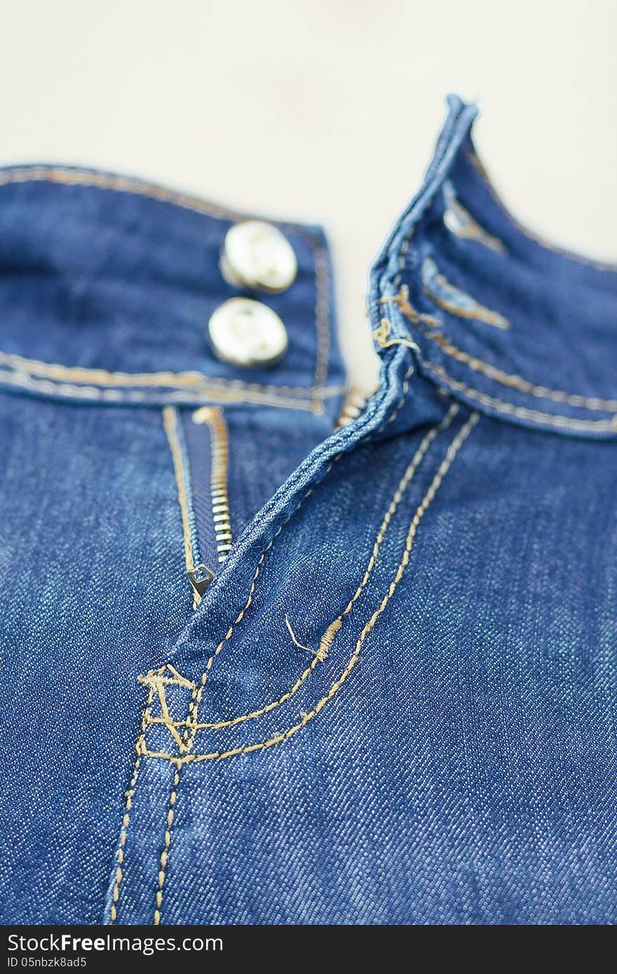 Zip on blue jeans with shallow focus. Zip on blue jeans with shallow focus