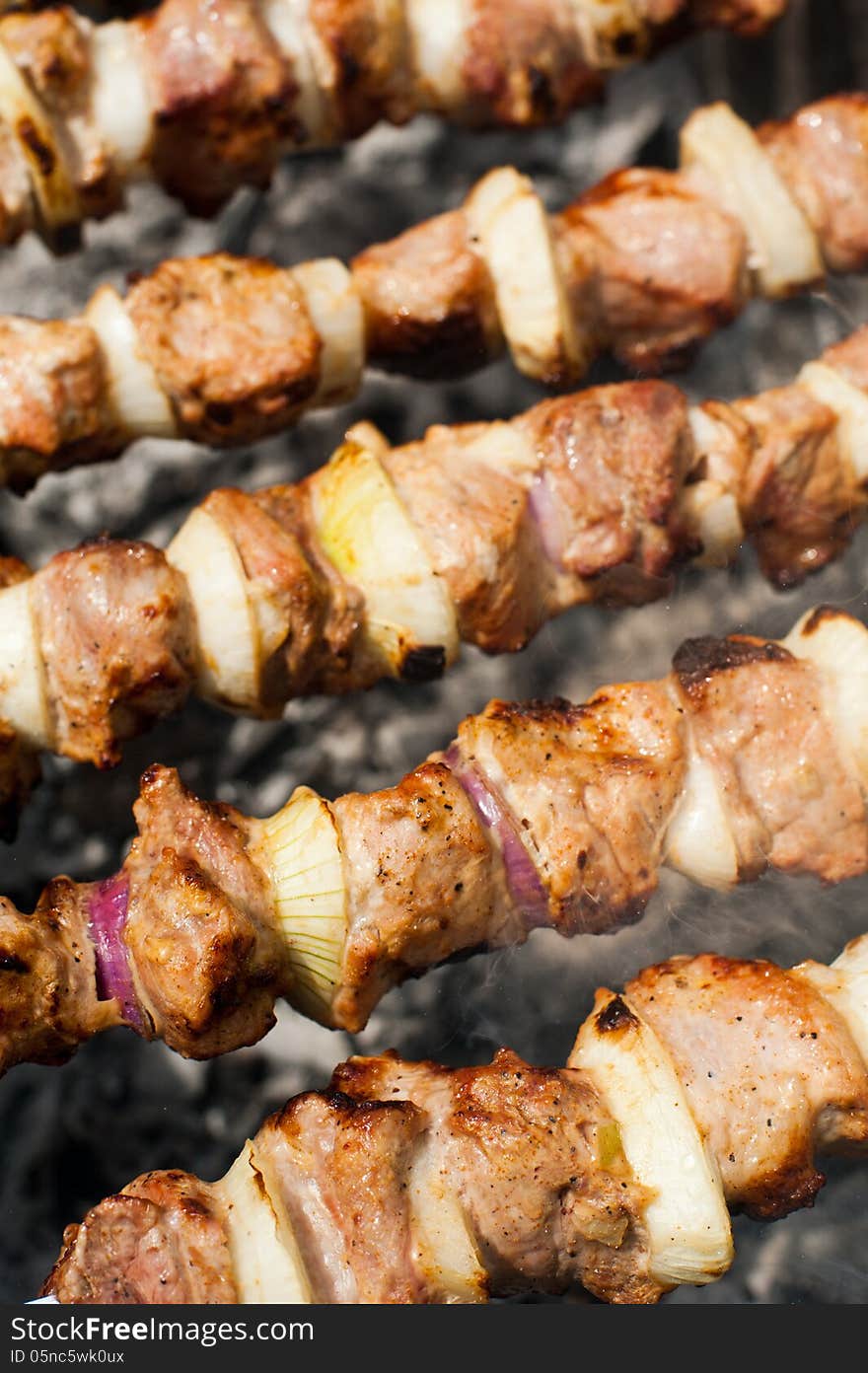 Cooking delicious shish kebab on outdoors grill