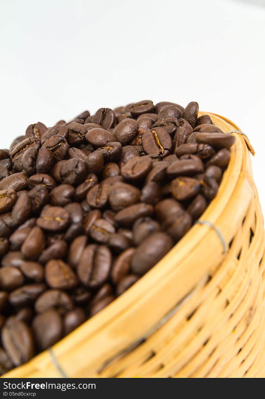 Close up coffee bean in basket isolate on white background