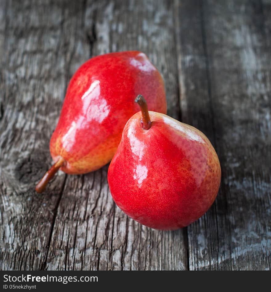 Composition with Two Pears on the dark wooden table, square image