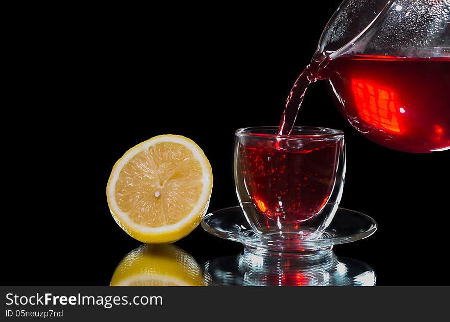 Tea Is Poured Into A Glass Cup