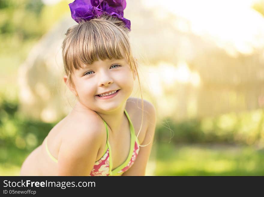 Portrait of a cute little girl on summer vacations with copy space