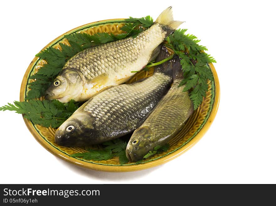 Three carp on ceramic dish , greens and lemon