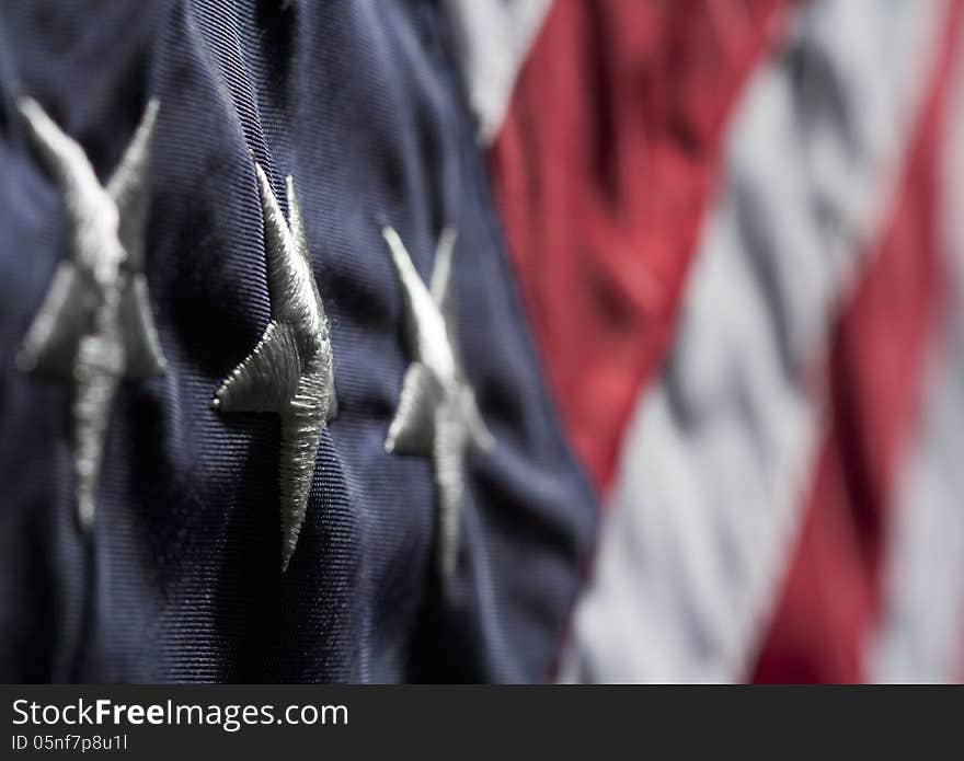 Horizontal close up shot of American flag. Shot diagonally with focus on a white star in blue field with blurred red and white stripes. Horizontal close up shot of American flag. Shot diagonally with focus on a white star in blue field with blurred red and white stripes