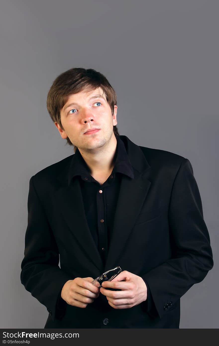 Portrait of intelligent man in a suit on gray background. Portrait of intelligent man in a suit on gray background