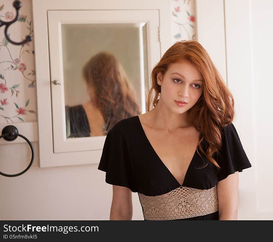 A portrait of a beautiful woman standing in front of a mirror. A portrait of a beautiful woman standing in front of a mirror