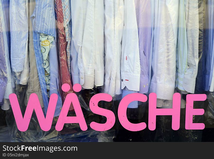 Sign And Shirts In The Window Of A Vintage German Laundromat