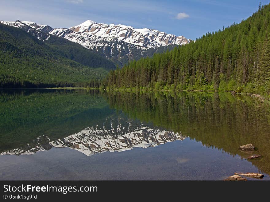 This image of the reflection of the snowy mountain in the water was taken at Stanton Lake in the Great Bear Wilderness of NW Montana. This image of the reflection of the snowy mountain in the water was taken at Stanton Lake in the Great Bear Wilderness of NW Montana.