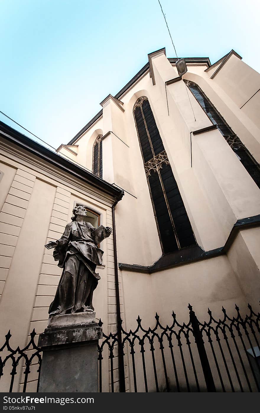 Old ancient statue in front of church i Lviv, Ukraine