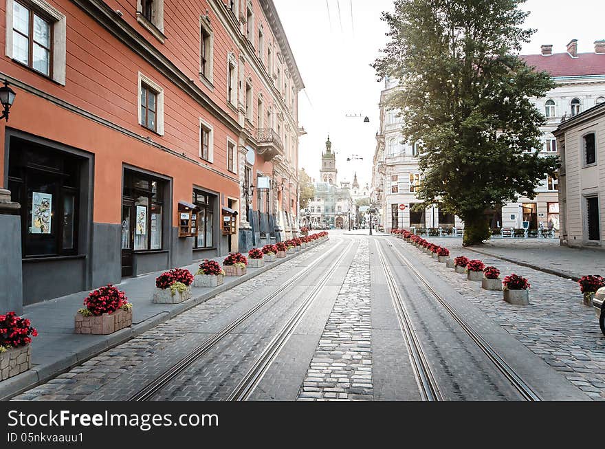 Old street in center of Lviv, Ukraine with flowers and tram line