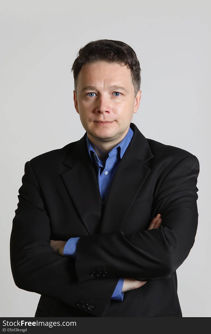 Portrait of intelligent middle-aged man in a suit on gray background. Portrait of intelligent middle-aged man in a suit on gray background