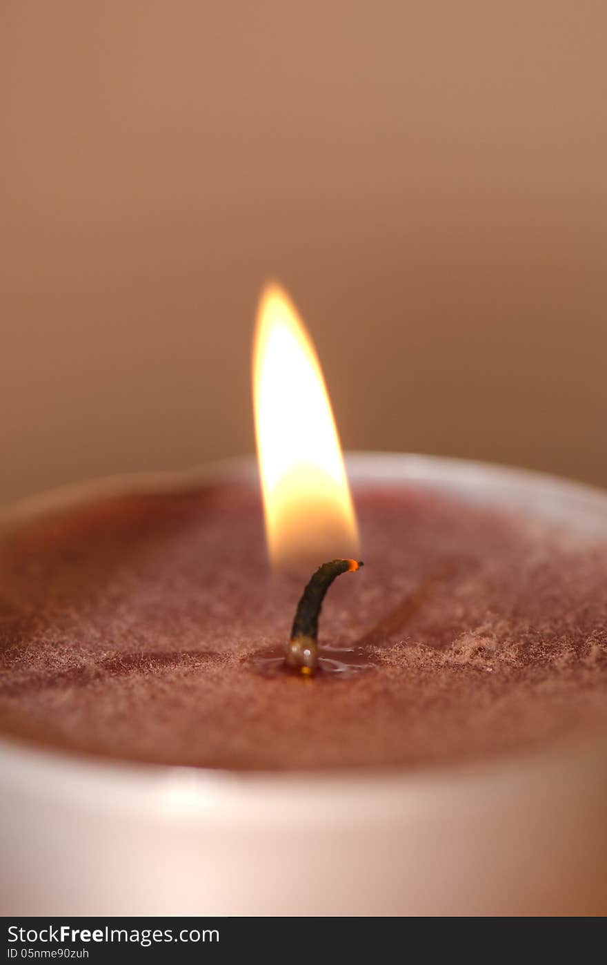 The light of a scented burning candle